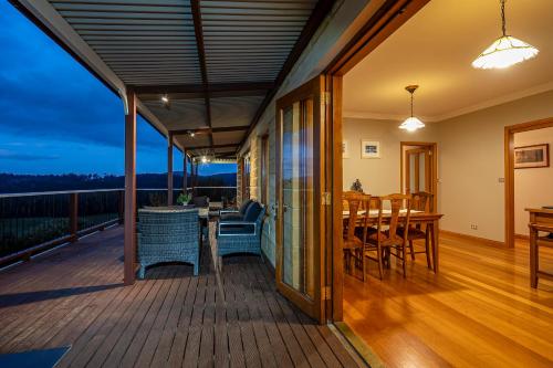 a balcony with a table and chairs on a deck at Manfield Country Bruny Island in Alonnah