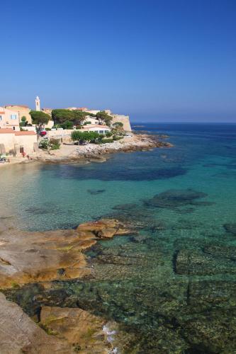an aerial view of a beach with the water at Hotel Beau Rivage in Algajola