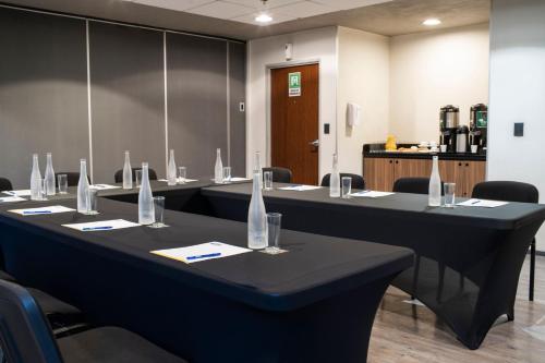 a meeting room with a long table with chairs at City Express by Marriott Santiago Aeropuerto in Santiago