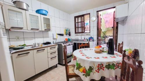 a kitchen with a table with a table cloth on it at Hospedagem Casa Da Lia in Lençóis