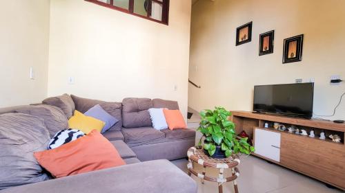 a living room with a couch and a flat screen tv at Hospedagem Casa Da Lia in Lençóis