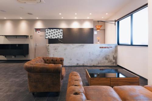 una sala de estar con 2 sofás y un bar en OKINI HOTEL namba en Osaka