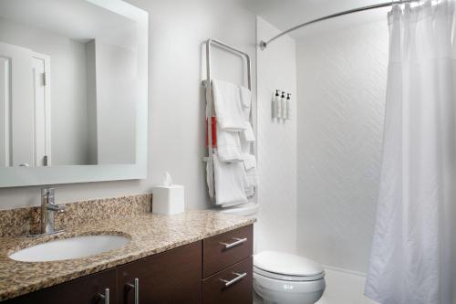 a bathroom with a sink and a toilet and a shower at TownePlace Suites by Marriott Savannah Airport in Savannah