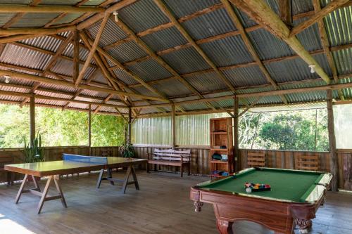 a large room with a pool table and awning at Vista Turrialba Lodge in Turrialba