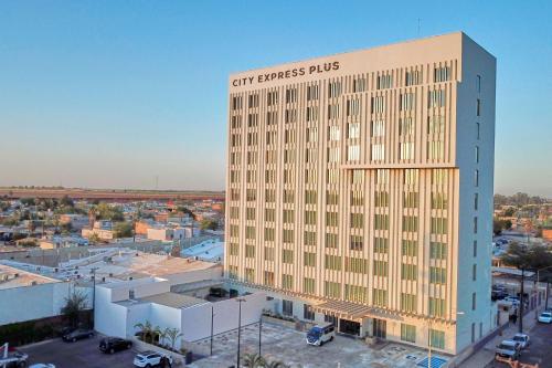 a tall building with a sign on the side of it at City Express Plus by Marriott Mexicali in Mexicali