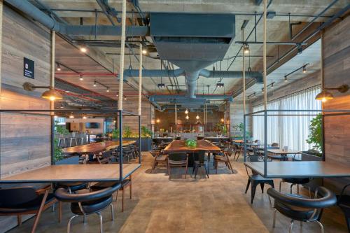 a restaurant with tables and chairs in a room at City Express Plus by Marriott Mexicali in Mexicali