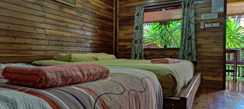 ジョムティエンビーチにあるMy dream house resortのログキャビン内のベッドルーム1室(ベッド2台付)