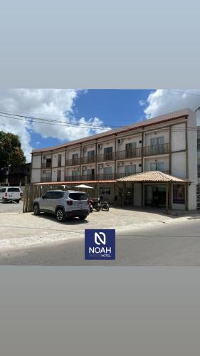 a building with a car parked in front of it at NOAH Rústico Hotel in Bôca da Mata