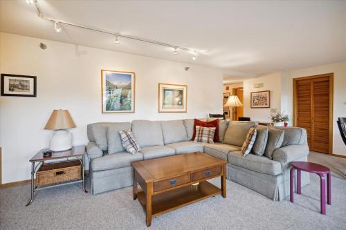 a living room with a couch and a table at Incredible Highridge 2 bedroom 2 bathroom with Indoor Pool A14 in Killington