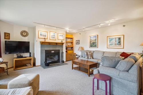 a living room with a couch and a fireplace at Incredible Highridge 2 bedroom 2 bathroom with Indoor Pool A14 in Killington