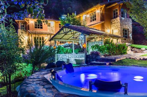 a hot tub in a yard next to a house at VILLA APU CHICON (Apu Wasi & Inti Wasi) in Urubamba