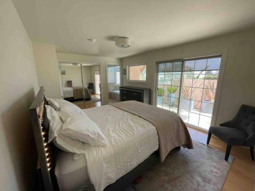a bedroom with a bed and a chair and a window at 3BD 3BR CityView Central San Francisco -15 min walk from Castro station in San Francisco