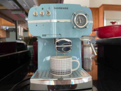 a blue coffee maker with a cup of coffee at 3BD 3BR CityView Central San Francisco -15 min walk from Castro station in San Francisco