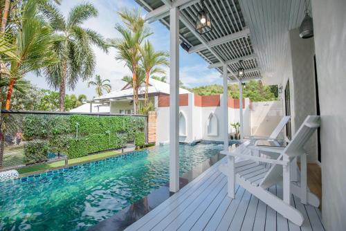 a view of a swimming pool from the balcony of a house at Seashell Village Resort in Chao Lao Beach