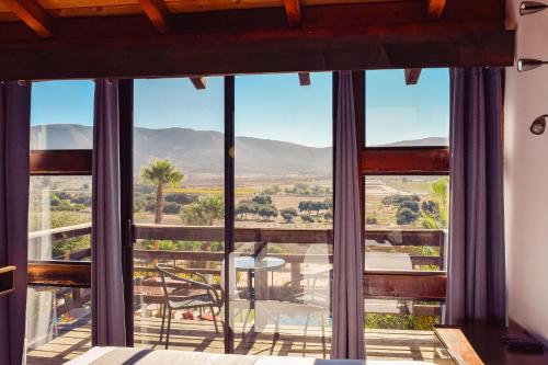 a room with a view of the desert through windows at Finca Selah in Ensenada