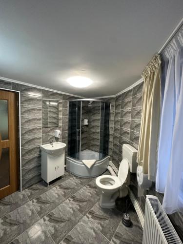 a bathroom with a toilet and a sink at Freedom&Relax in Buzău