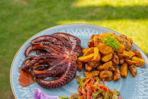 a plate of food withopus and vegetables on a table at RCH LUXURY HOTEL & POOL in Dibulla