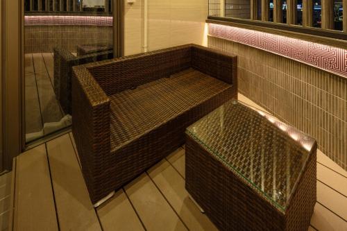 two benches sitting in a room with a light at ホテル ブルジュア 久留米 Hotel Bvljua -レジャーホテル- in Kurume
