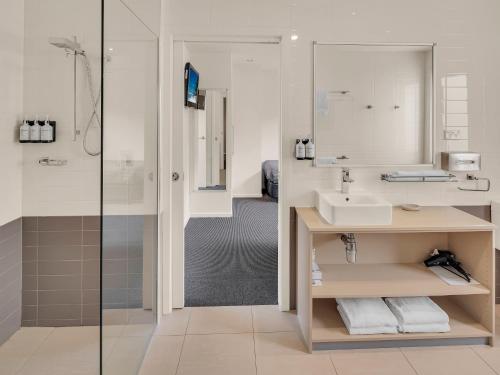 a bathroom with a sink and a shower at BIG4 Ingenia Holidays Queenscliff Beacon in Queenscliff