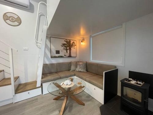 a living room with a couch and a table at Little River at Sussex Inlet in Sussex inlet