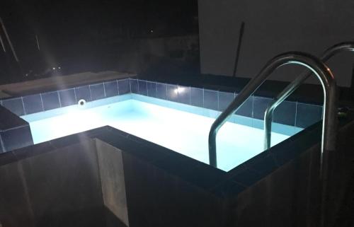 a swimming pool with lights in a dark room at No 10 @ Carlwil place in Colombo