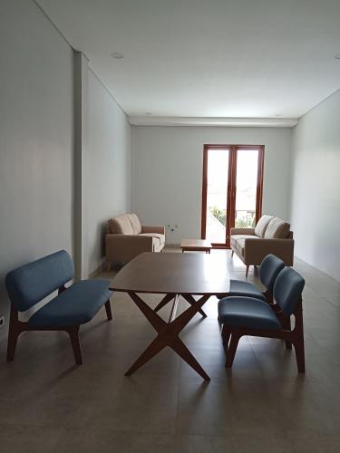 a living room with a wooden table and chairs at Mesari Villa in Keramas