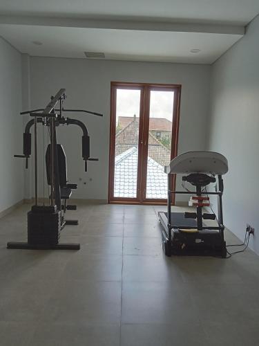 a gym with two exercise bikes and a window at Mesari Villa in Keramas