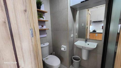 a small bathroom with a toilet and a sink at CasaLaila in Davao City