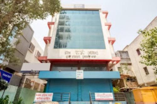 a building with a blue front with a sign on it at Hotel Rahi,Nashik in Nashik