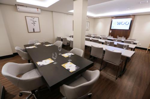sala konferencyjna z długim stołem i krzesłami w obiekcie 4WOO w mieście Telêmaco Borba