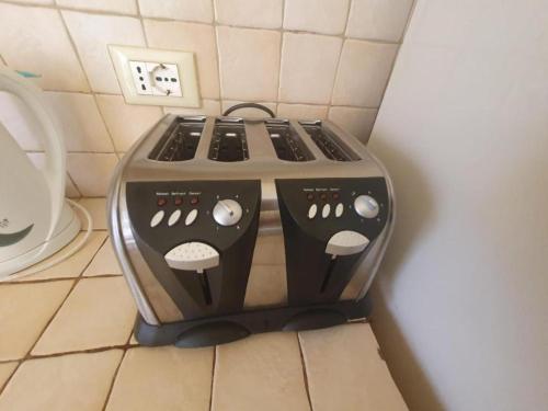 a stove top oven sitting on a kitchen floor at Sun & Beach Holiday in Santa Maria
