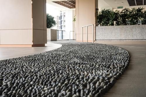 a large group of birds sitting on the floor of a building at K Avenue by Pinstay in Donggongon