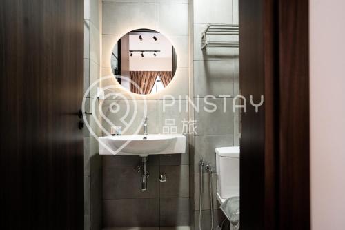 a bathroom with a sink and a mirror at K Avenue by Pinstay in Donggongon