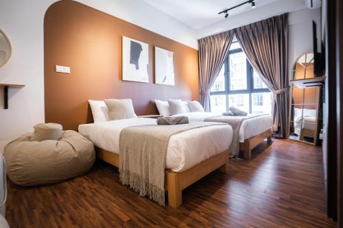 a bedroom with two beds and a large window at K Avenue by Pinstay in Donggongon