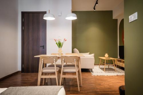 a dining room with a table and four chairs at K Avenue by Pinstay in Donggongon