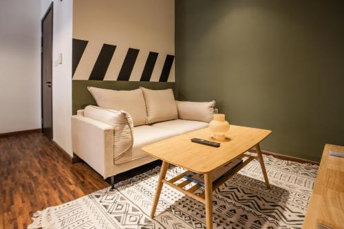 a living room with a couch and a table at K Avenue by Pinstay in Donggongon