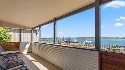 a balcony with chairs and a view of the water at Walshys Shack in Coffin Bay