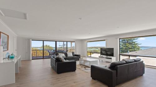 a living room with two couches and a television at Bimbadeen in Coffin Bay