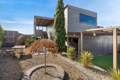a house with a small garden in front of it at Escape to Coastal Tranquility in Primrose Sands