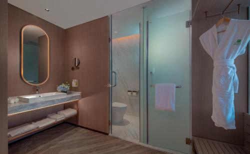 a bathroom with a glass shower and a sink at Holiday Inn Beijing Focus Square by IHG in Beijing