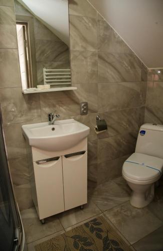 a bathroom with a sink and a toilet at Готель Бережани in Brzezhany