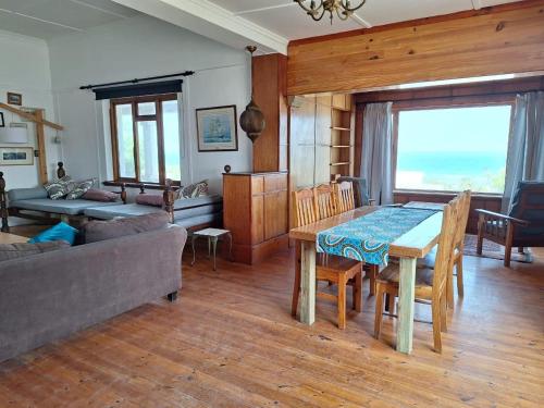 a living room with a table and a couch at Yield House and Cottages in Port Nolloth