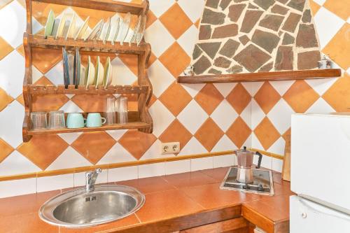 a kitchen with a sink and a counter top at Casita Frigiliana in Frigiliana
