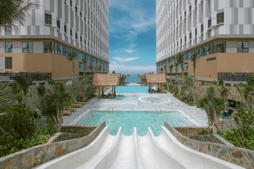 a swimming pool in the middle of a building at Mandala Cham Bay Mui Ne in Phan Thiet