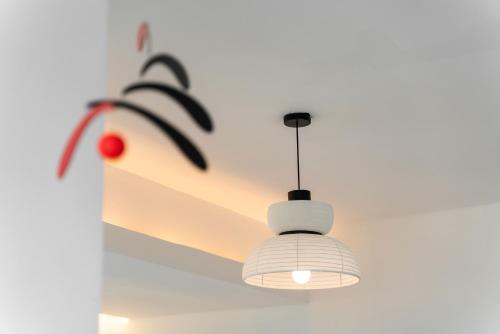 a ceiling light hanging from a white wall at Shanghai Yi Du B&B - Family Suite 500m to Nanjing West Rd Near People's Square -Credit Cards Accepted in Shanghai