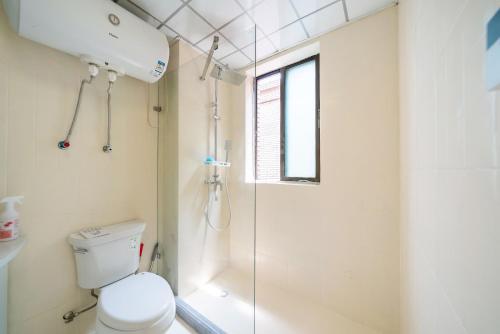 a bathroom with a toilet and a shower at Shanghai Yi Du B&B - Family Suite 500m to Nanjing West Rd Near People's Square -Credit Cards Accepted in Shanghai