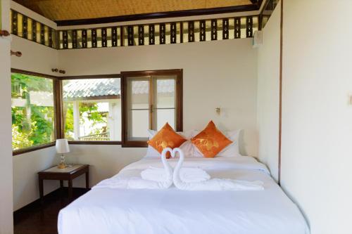 a bedroom with a bed with swans on it at Lamai bayview boutique resort in Koh Samui 
