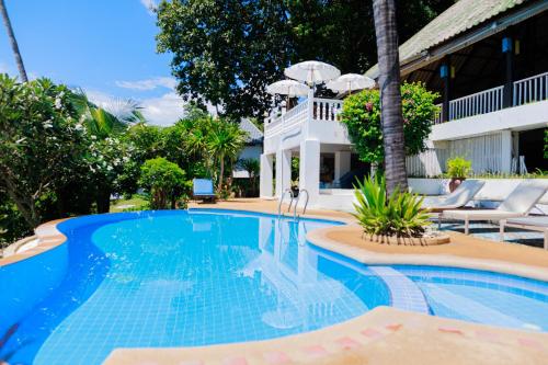 a swimming pool in front of a villa at Lamai bayview boutique resort in Koh Samui