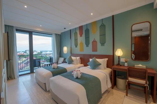 a hotel room with two beds and a balcony at Cozy An Boutique Hotel Hoian in Hoi An