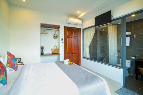 a bedroom with a large bed and a television at Phuoc Dat Riverside Homestay Hoi An in Hoi An